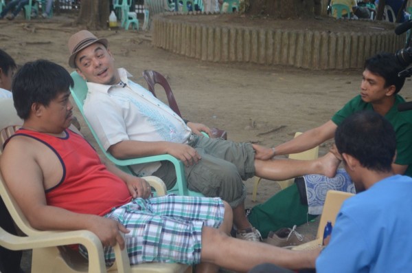 After all long day of walking, Celdran indulges in a quick foot massage at the park under the shade of the trees.