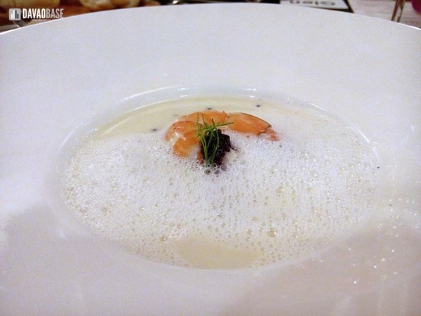Veloute of seafood with poached sea scallop, white fish, clams, and pomelo tempura