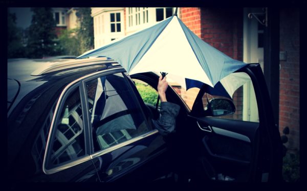 Here's one frustrating umbrella experience: How to get inside the car without getting wet!